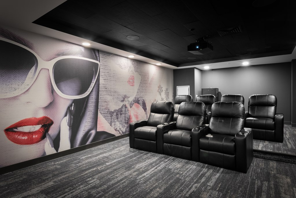 a room filled with furniture and a large mural of a woman